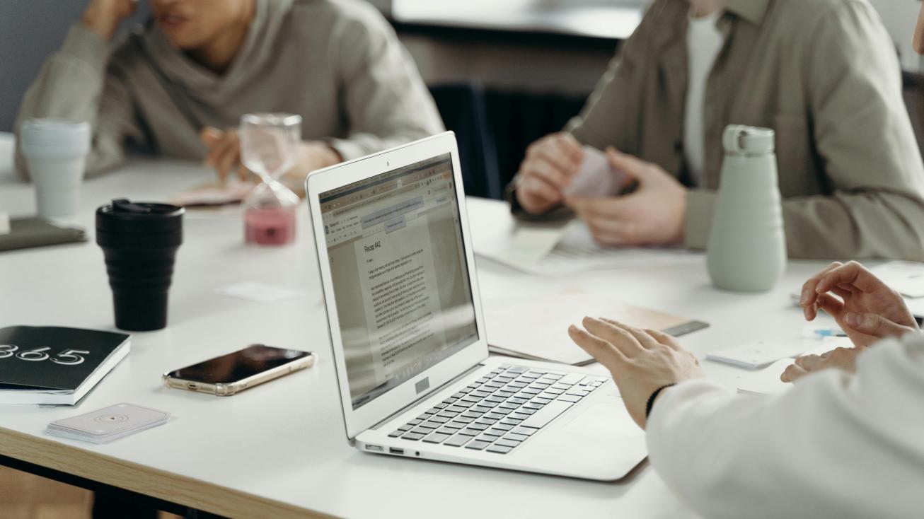 Students sitting with a laptop